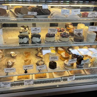 a display case of cakes and pastries