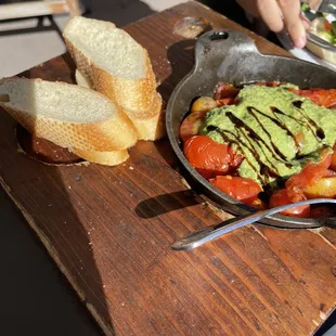 a plate of food with bread and avocado