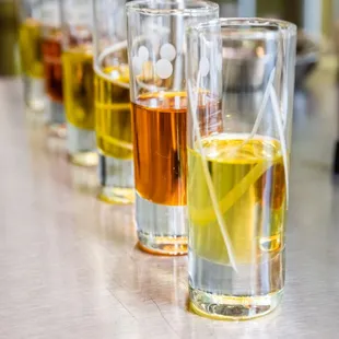 a row of glasses of olive oil