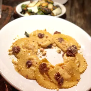 a plate of ravia and a plate of salad