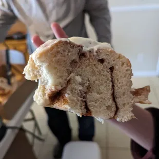 a person holding a half eaten pastry