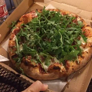 Build your own: prosciutto, carmelized onions and arugula.