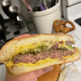  hand holding a half eaten sandwich