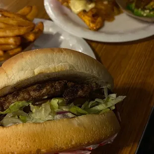 Burger and Mushroom grilled chicken burger with side of fries and jalapeños.