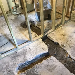 a hole in the floor of a kitchen being remodeled