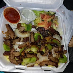 This is a Gyro plate runs about 12 dollars!! There is yellow rice under the meat onions and peppers! Definitely filling and a must try!