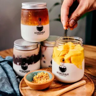 a jar of yogurt and a bowl of fruit