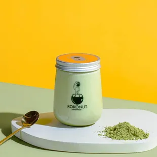 a jar of matcha powder and a spoon