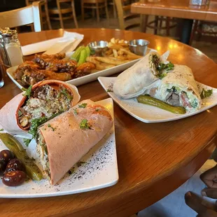 Lamb Shawarma to the right and Mediterranean Chicken Pita Wrap with Sriracha  wings