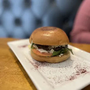 a burger on a plate on a table