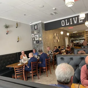 a group of people sitting at tables in a restaurant