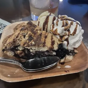 Berry pie with ice cream, homemade cream, and drizzled blueberry balsamic