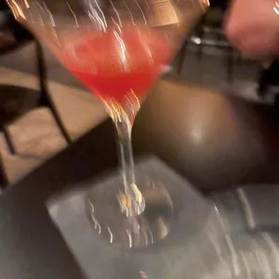 a red drink in a martini glass