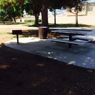 3 picnic tables, each with a grill