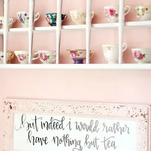a shelf of teacups