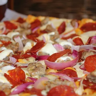 pepperoni, sausage, onions, and cheese