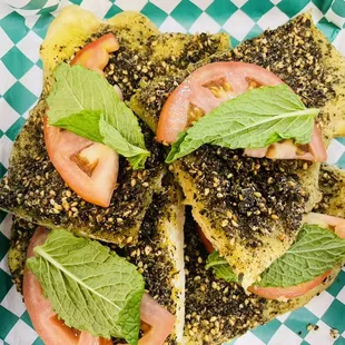 Flatbread Za'atar with a slices of tomato and a couple of fresh mints