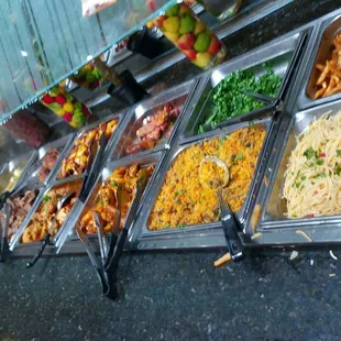 Brazilian buffet rice, veggies, chicken, ribs, beef stew, fries, plantain, fish, salad bar