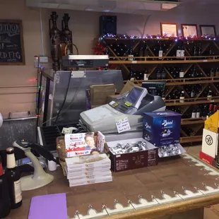 a wine shop with many bottles of wine on the counter