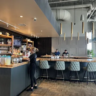 a woman standing at the bar