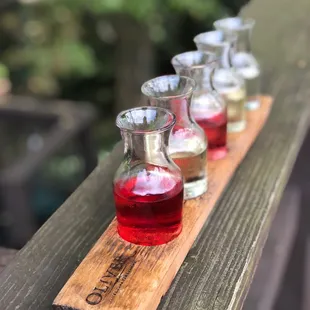 a row of wine glasses on a wooden table