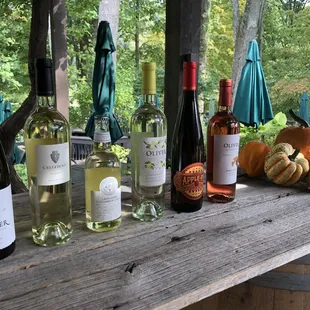several bottles of wine on a wooden table