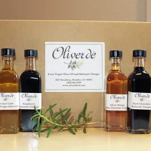 three bottles of olive oil and a box of olive oil