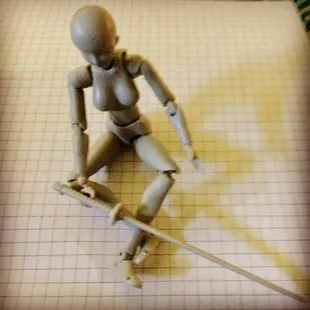 a wooden figure on a skateboard