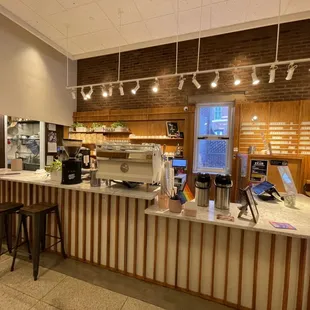 a coffee shop with a counter and stools