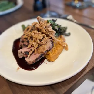 The Pork Tenderloin was served with a Chili Sweet Potato Mash, Sauteed Swiss Chard, and Crispy Shallots served on bed of Cherry Gastrique.