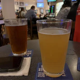 two glasses of beer and a cell phone