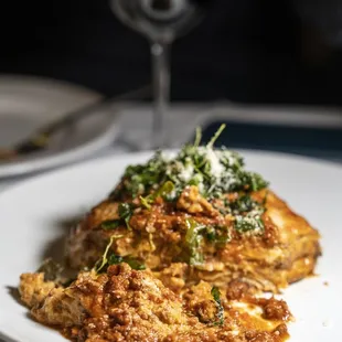 LASAGNA CLASSICA Homemade layer pasta with Bolognese sauce, bechamel crispy arugula