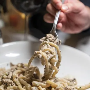 STROZZAPRETI ALLA NORCINA Homemade egg free pasta, pork sausage, porcini mushrooms, light cream, black truffle