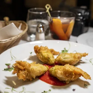 FIORI DI ZUCCA Lightly fried zucchini blossom, stuffed with ricotta cheese, Anchovies, capers,tomato sauce