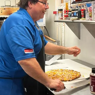 a man making a pizza