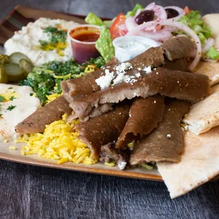 Gyro plate with tzaziki, hummus, baba ganoush, greek salad and pita
