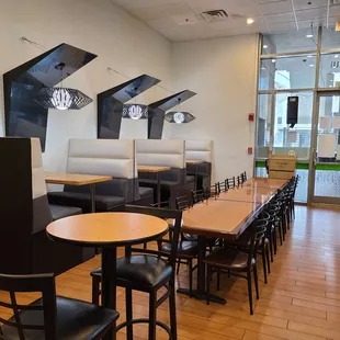 a dining area with tables and chairs