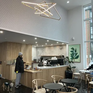 a woman standing in a coffee shop