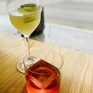 two cocktails on a wooden table