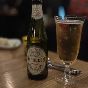 a bottle of beer and a glass on a table