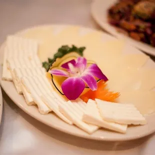 a plate of cheese and vegetables