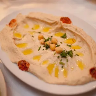 a plate of hummus and a bowl of salad