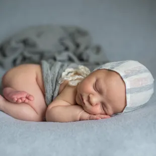 Newborn boy portrait on handmade sewn bonnet piece.