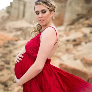 Maternity photoshoot at red rock state park with flowing red dress