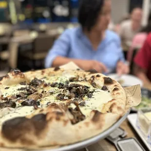 The fungi pizza has a béchamel sauce and truffles.