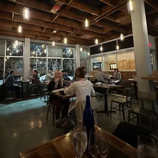 people sitting at tables in a restaurant