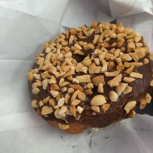 Chocolate covered with nuts bready donut