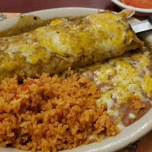 Shredded beef burrito combination plate with chili verde sauce.