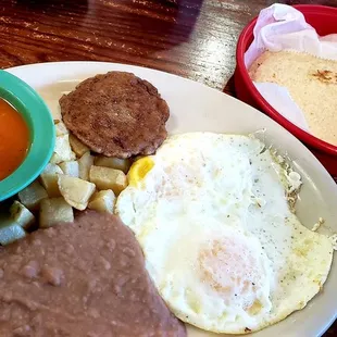 My Huevos Rancheros with sausage patty and corn tortillas substituting for bacon and flour tortillas. I has my eggs over medium.
