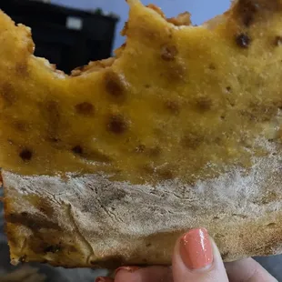 Cheese and pepperoni pizza not properly rolled out. Just a pit of grease or flour.